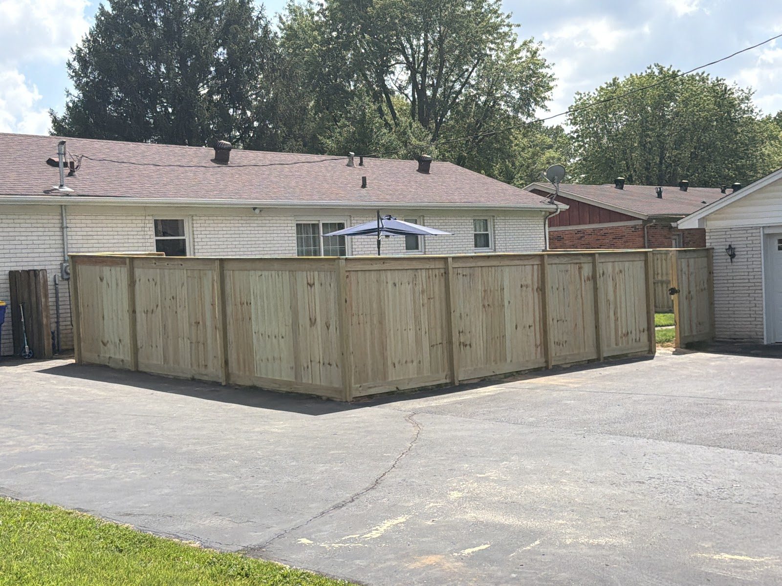 Wood privacy fence by a driveway