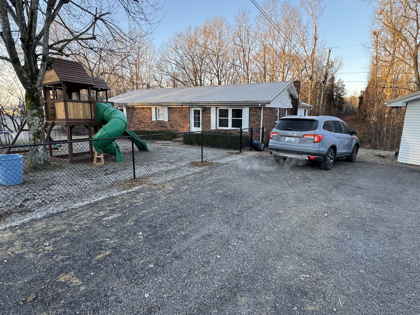 Black chain link fence along a driveway
